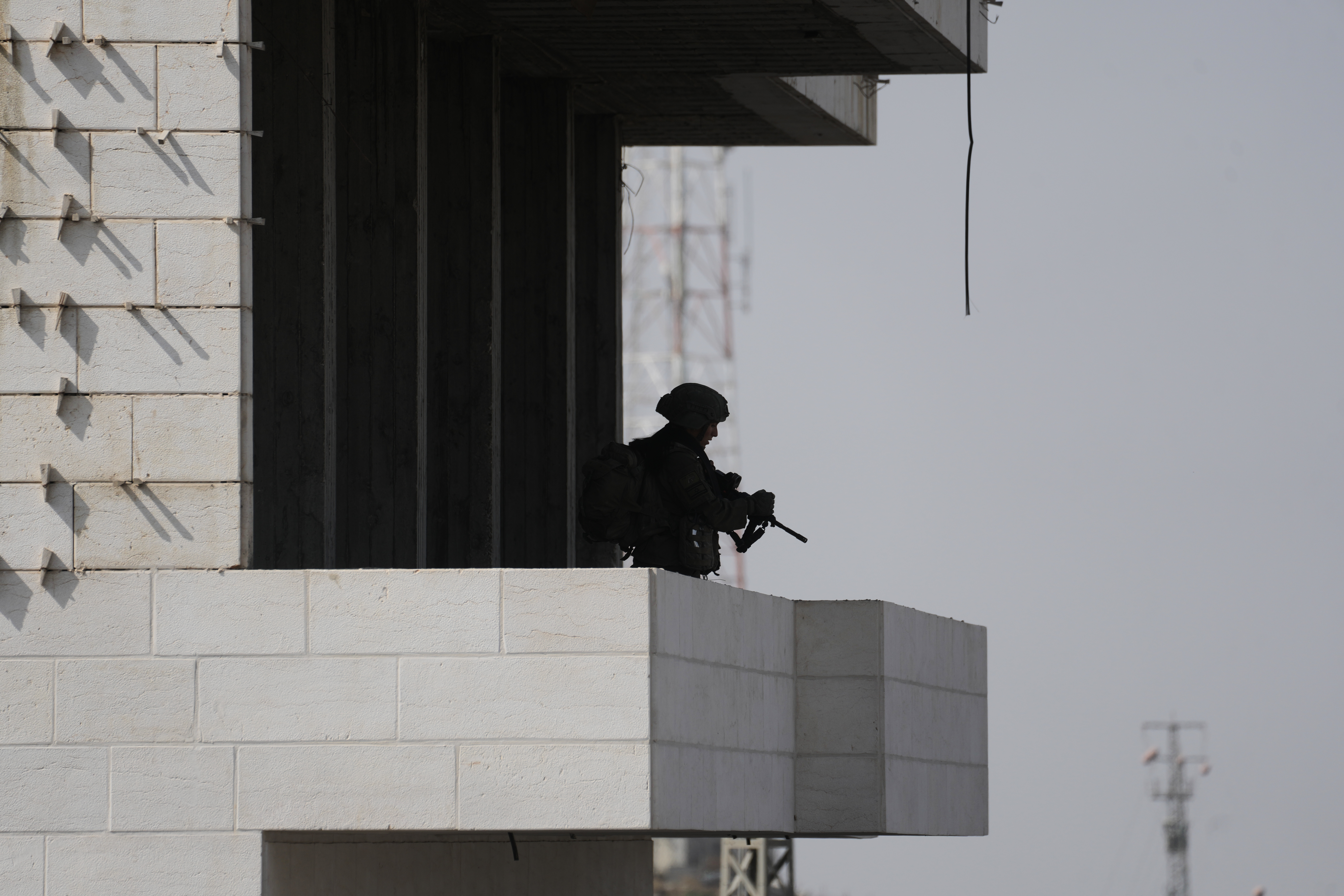 Israeli soldiers take up positions during an army operation in the West Bank city of Hebron, a day after a Palestinian shooting attack in the area. (AP)