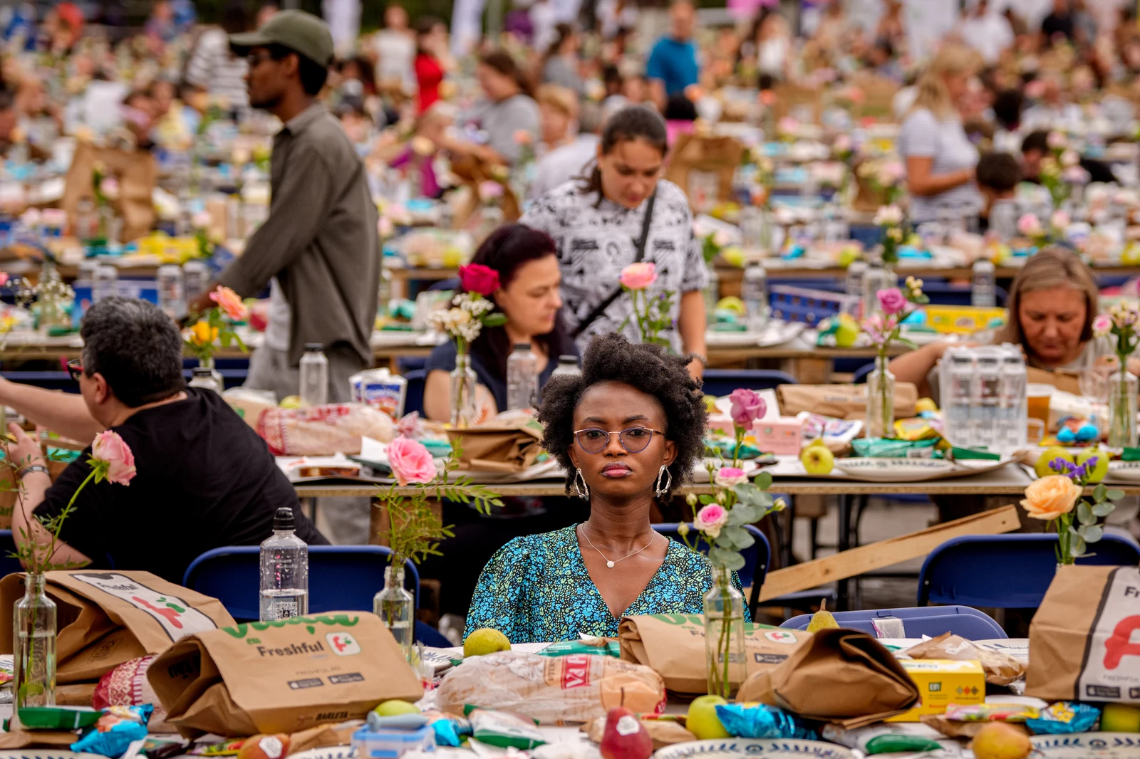 A woman sits at a 5-kilometer (3.1 miles) long "Uniting Table", made from recycled materials, during a Guinness World Record event to raise money for a children's psychiatric facility, in Buchares, Sept. 12, 2026. (AP)