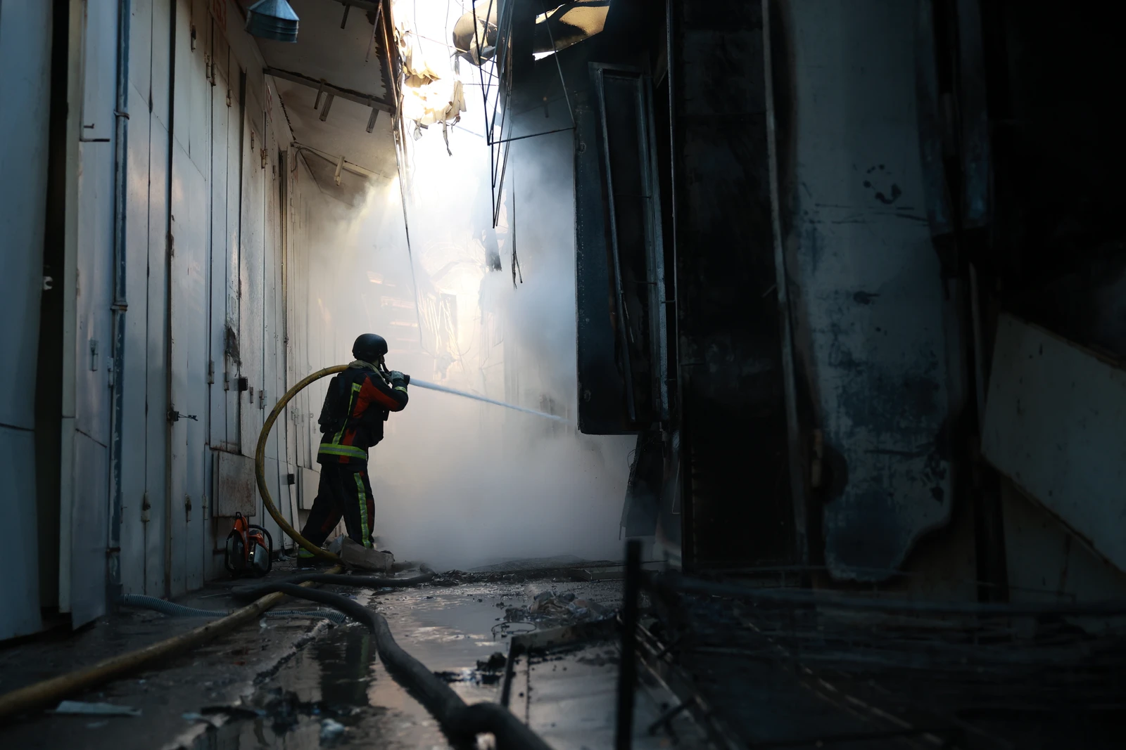 A rescue worker puts-out a fire of the central market damaged in a Russian strike on Zaporizhzhia, Ukraine, on Saturday. (AP)